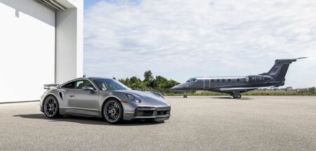 The Phenom 300E light jet and Porsche 911 Turbo S sports car