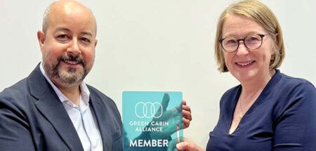 Elina Kopola, founder of the Green Cabin Alliance, presenting the members' plaque to Richard D’Cruze, business development director at JPA Design