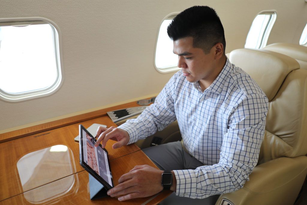 Man using tablet on business jet