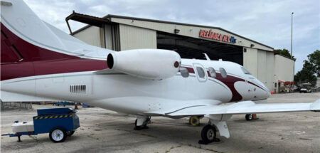 Phenom 100 in front of hangar