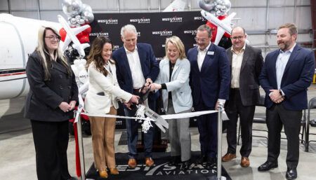 ribbon cutting group photo in hangar