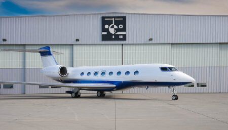 business jet in front of hangar