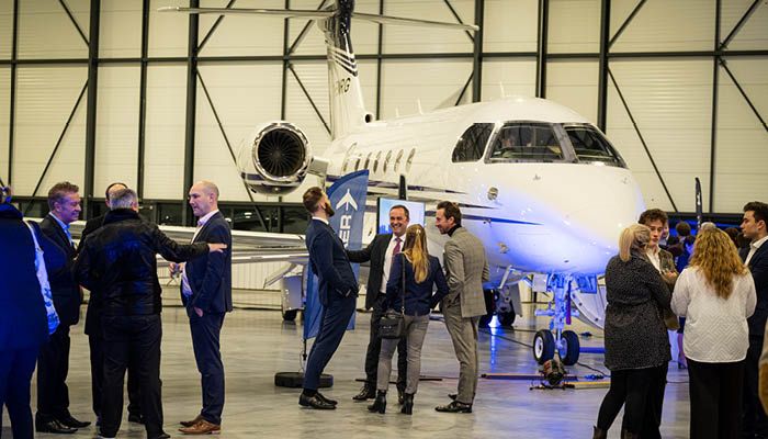 Guests in front of the Praetor 600 aircraft at the celebratory event