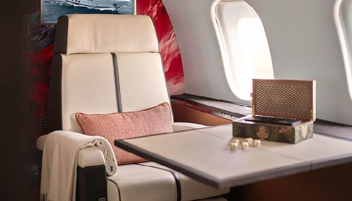 Global 5000 interior with table and leather seat in foreground, art wall behind