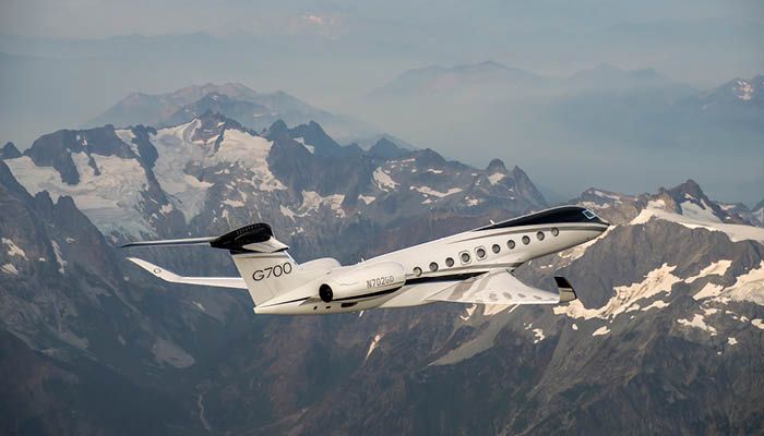 Gulfstream G700 in flight over mountains