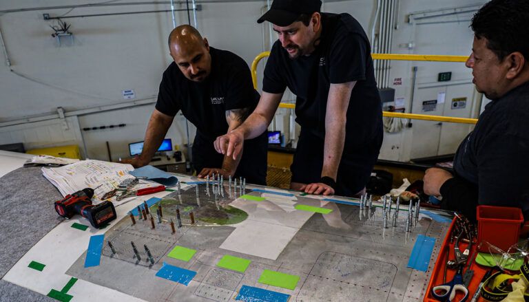 aircraft fuselage being prepared by technicians