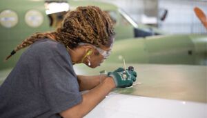 Textron Aviation specialist working on aircraft wing