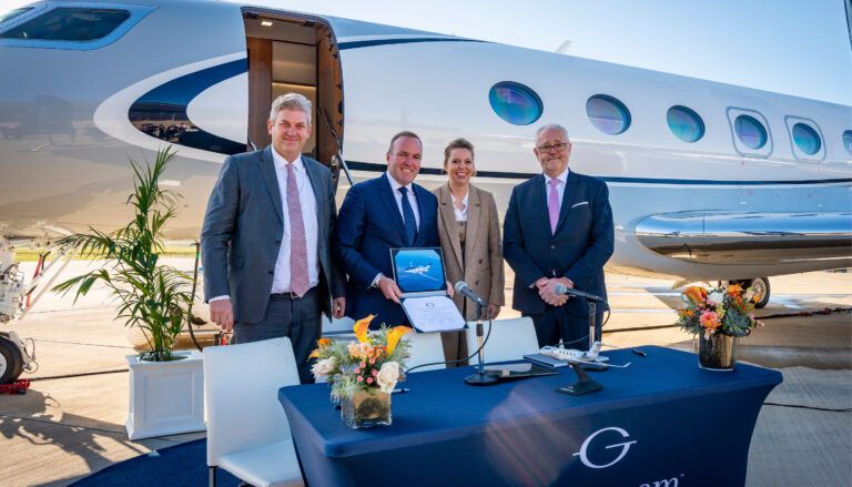 Signing ceremony in front of an aircraft