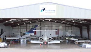 Plane Place Aviation hangar with three aircraft inside