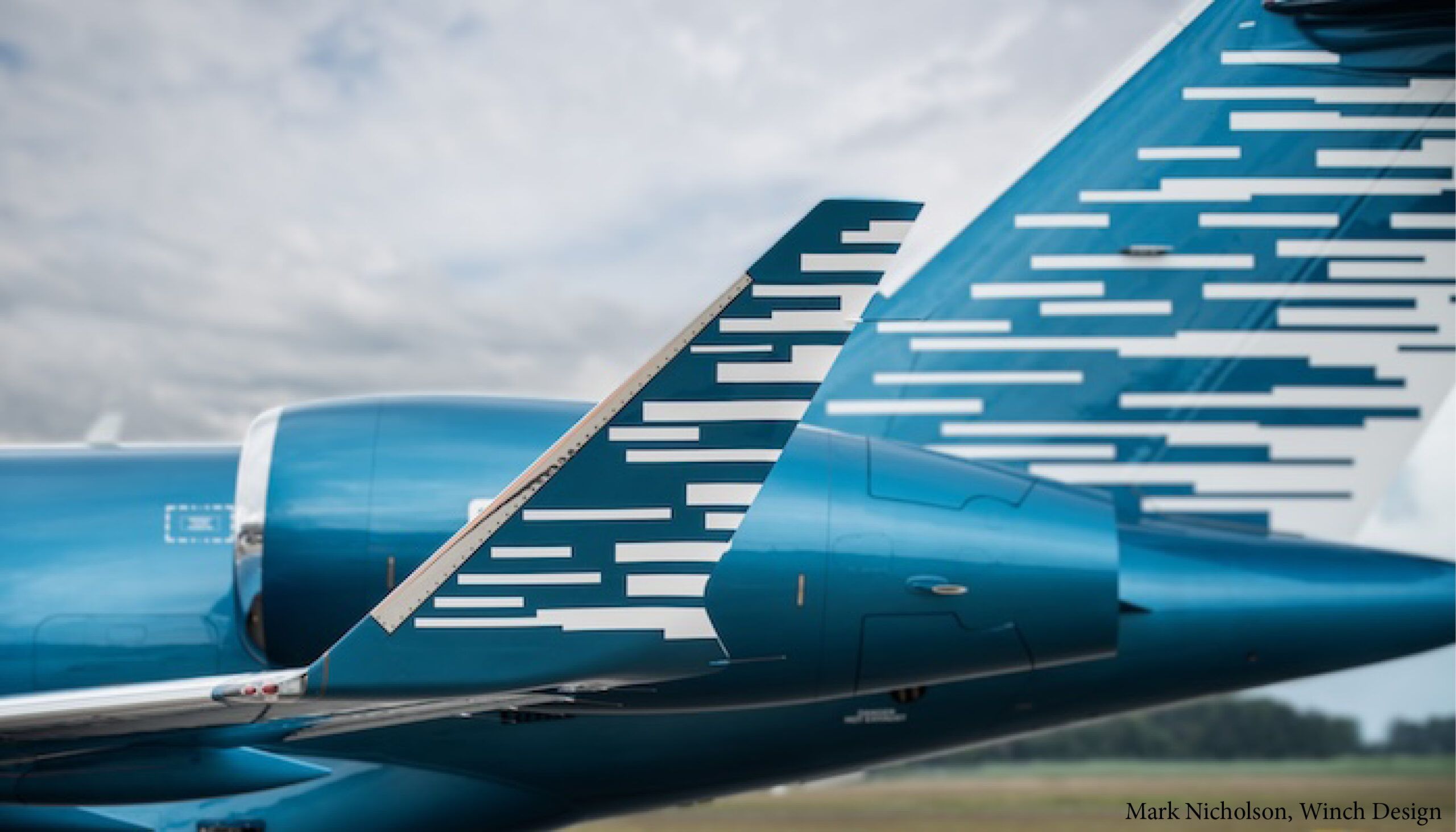 aircraft exterior livery with teal blue base and white horizontal lines