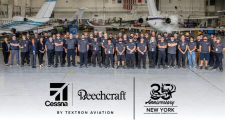 Group photo in hangar with aircraft