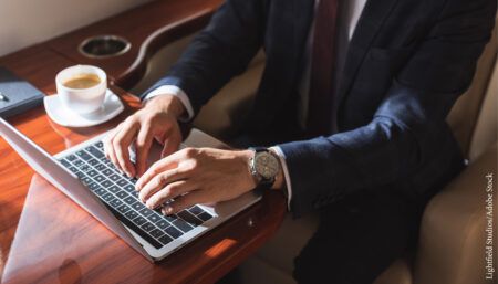 businessman using laptop on private jet