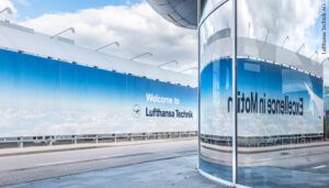 facility exterior with wall covered in banner reading 'Welcome to Lufthansa Technik'