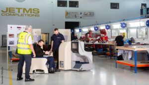 JetMS facility with people trying out aircraft seat