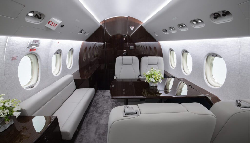 Falcon 2000EX interior - divan opposite a club-four with table