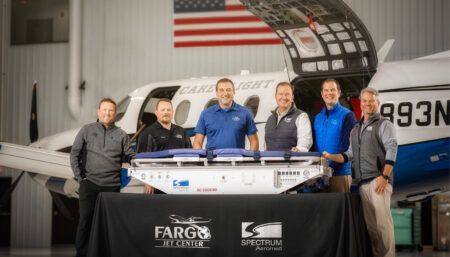 Group photo in front of aircraft