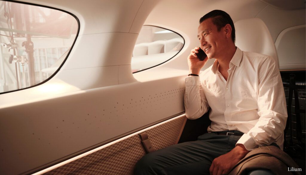 Man on phone in seat looking out of window