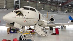 business jet undergoing maintenance in hangar