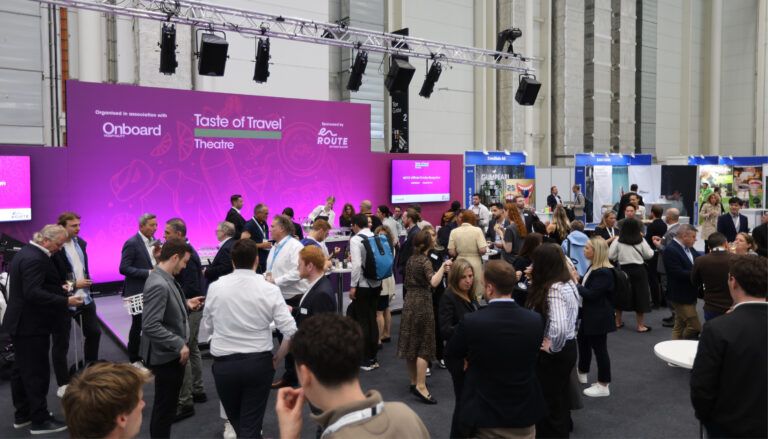 Conference with lots of people, stage in background