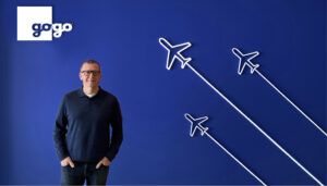 Chris Moore in front of blue backdrop with Gogo brand logo and aircraft outlines