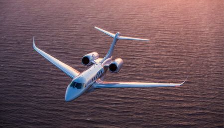 business jet flying over water