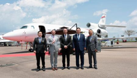 group photo in front of aircraft