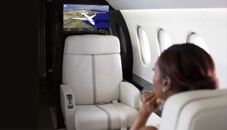 passenger on business jet looking at screen