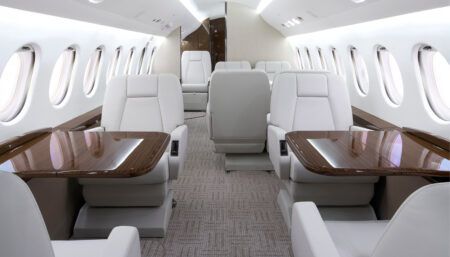business jet interior with light cream/white seats and brown veneer