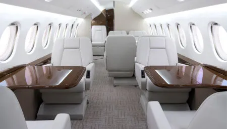 business jet interior with light cream/white seats and brown veneer