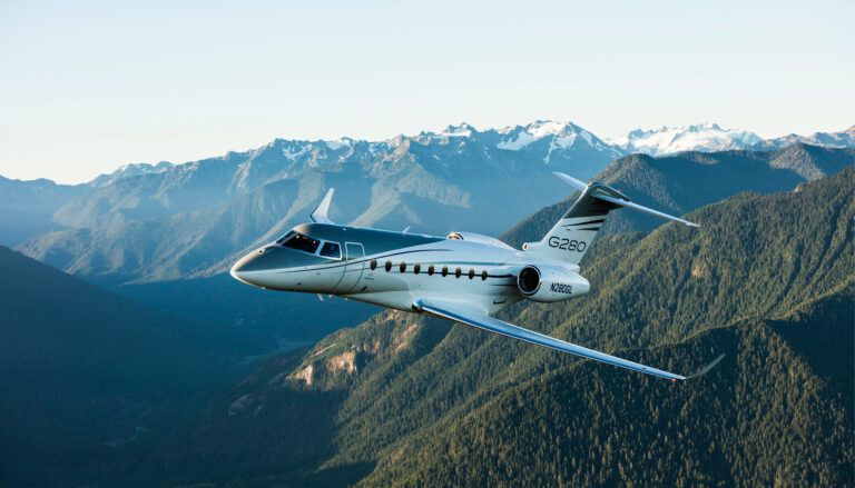 Gulfstream G280 in flight over mountains