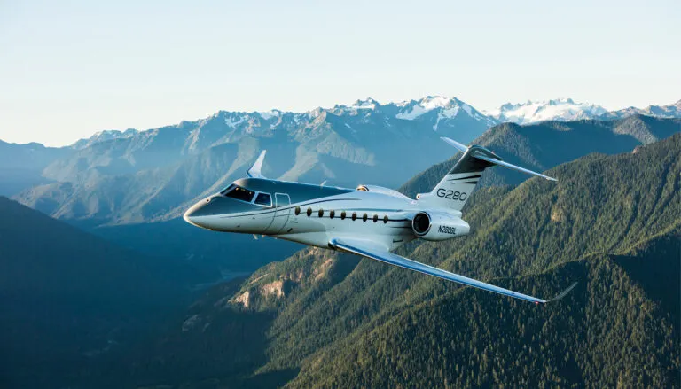 Gulfstream G280 in flight over mountains