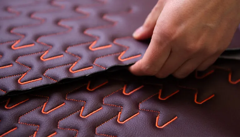 PriestmanGoode and Gen Phoenix reveal Essence Nappa at AIX 'Oxblood'-coloured material with 'Coral'-coloured embroidery
