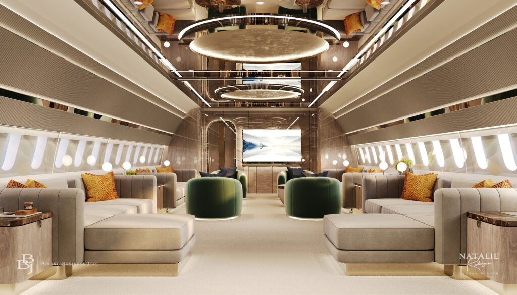 luxury aircraft lounge with symmetrical layout featuring cream divans in foreground, then green upholstered seating, with view towards screen. Luminous circular elements above.