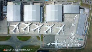 Bird's eye view of aircraft hangar complex with five B747-8i aircraft and other smaller types parked on the apron
