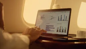 closeup of hands touching laptop, on private jet