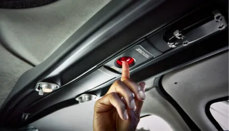 ceiling of private aircraft with person pressing red button