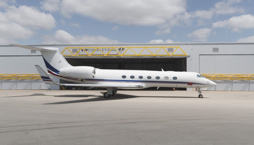 G550 parked on tarmac outside hangar facility