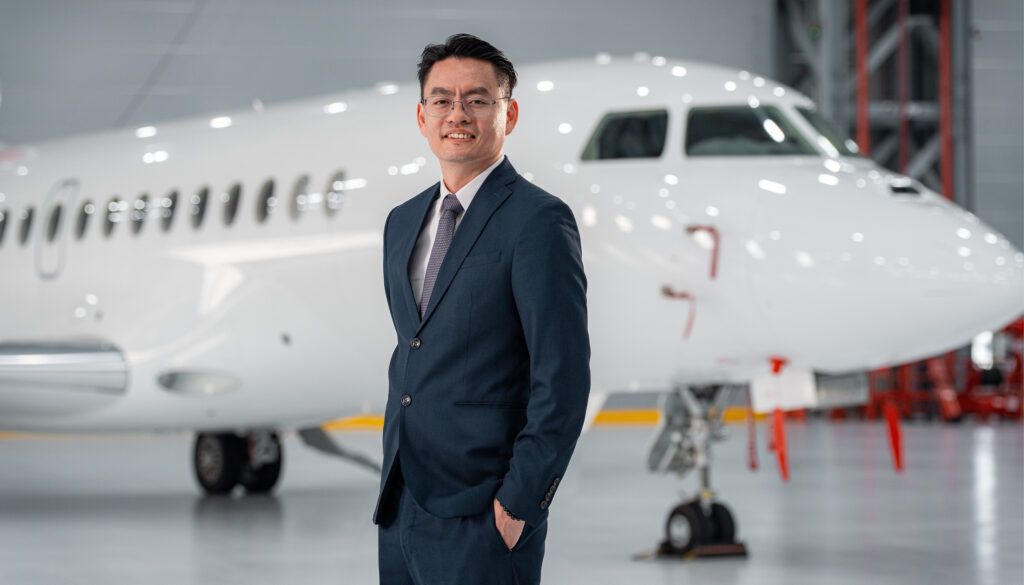 Ivan Lim in front of an aircraft in hangar