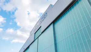 aircraft hangar exterior - large green building with Jet Aviation logo at the top