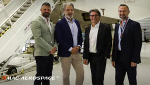 Group photo in front of aircraft in hangar