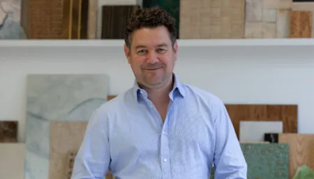 Headshot of Mike Sutton, with material samples in the background