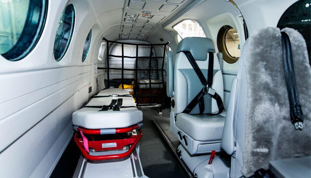 Aircraft interior with stretcher for patient transport, and seats