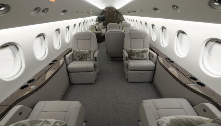 Luxurious private jet interior with beige leather seats and wood accents