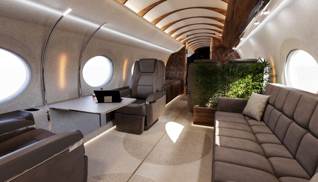 Spacious jet cabin featuring brown divan and seats, cream carpet with large circle pattern, chrome accents, living plants, geometric patterned bulkheads and wooden rib design on ceiling
