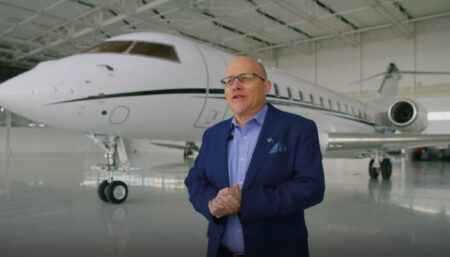 Thomas Chatfield in front of Global 6000 in aircraft hangar