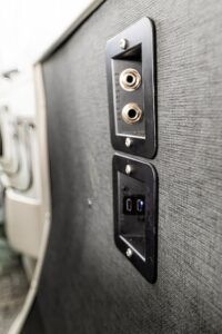 Aircraft interior wall panel showing audio jacks and USB charging ports