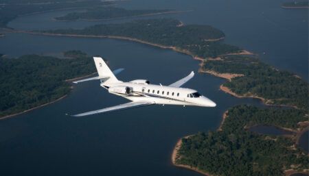 Private jet in flight over islands