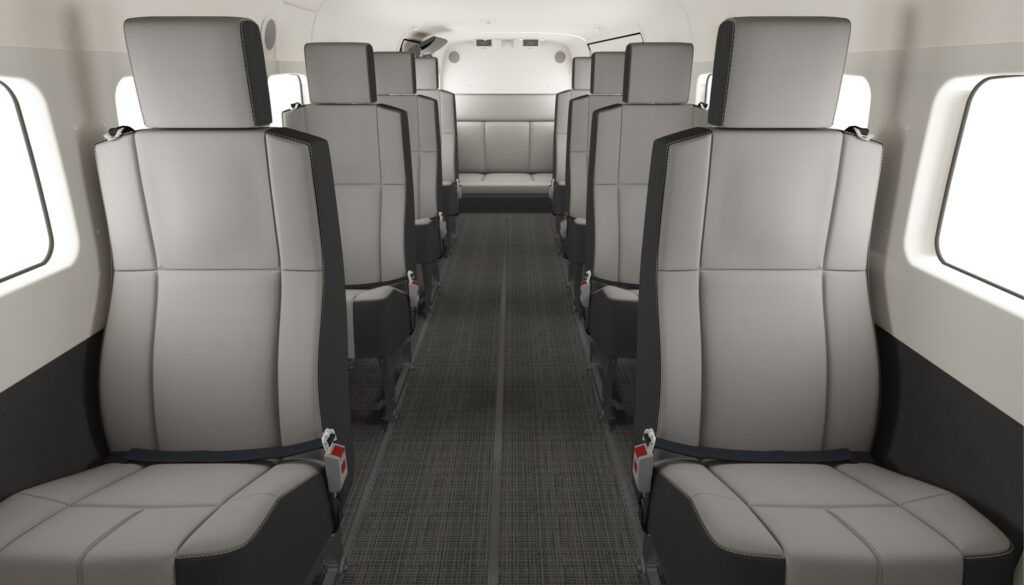 Aircraft cabin with light neutral leather seats in forward-facing rows with centre aisle