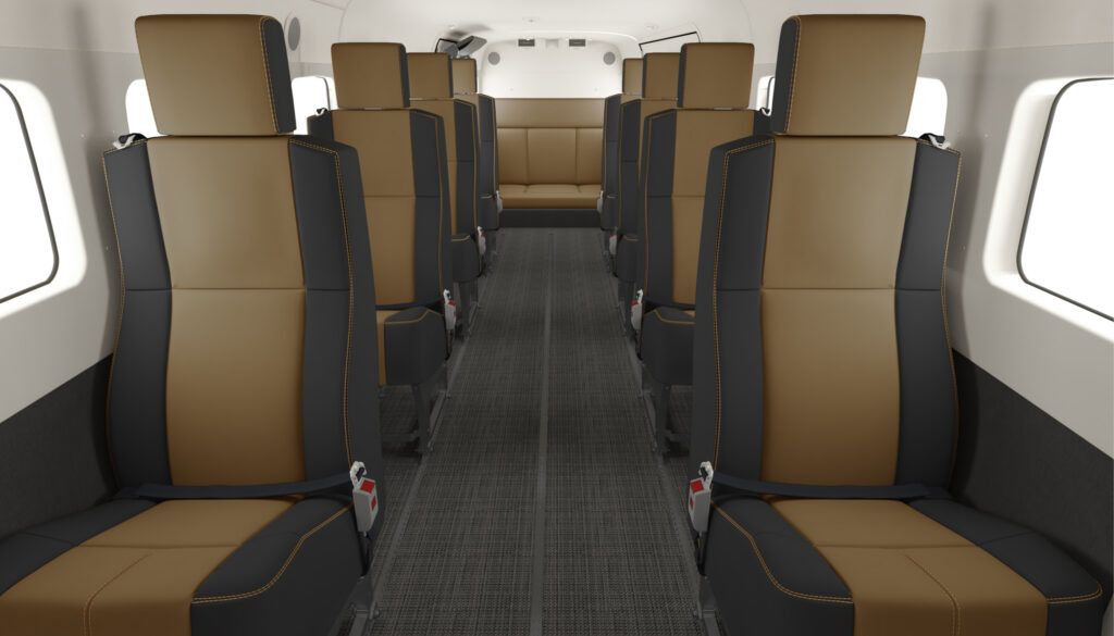 Aircraft cabin with tan and black two-tone leather seats in forward-facing rows with centre aisle