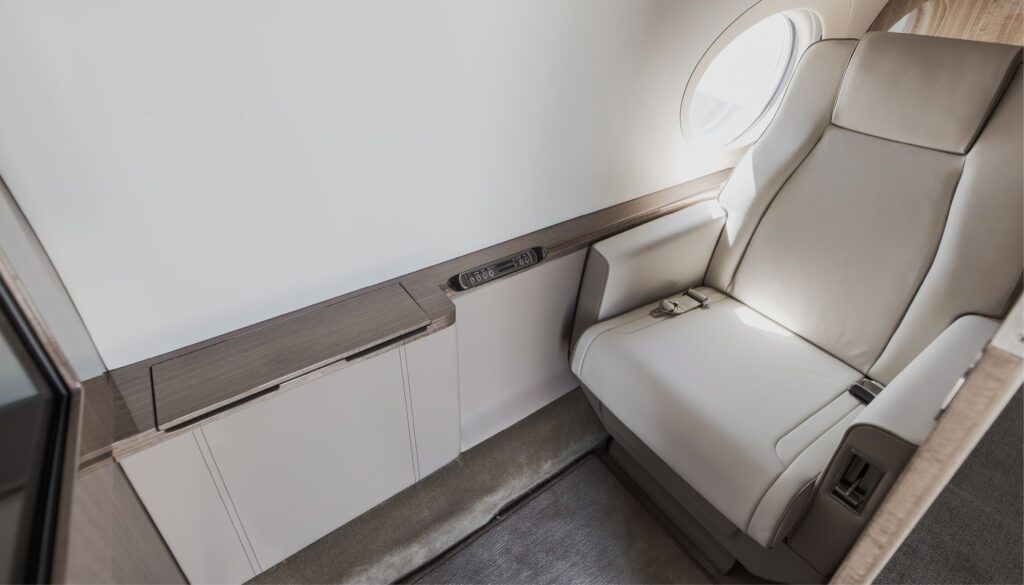 G550 interior – seat next to sideledge with stowed table, facing screen
